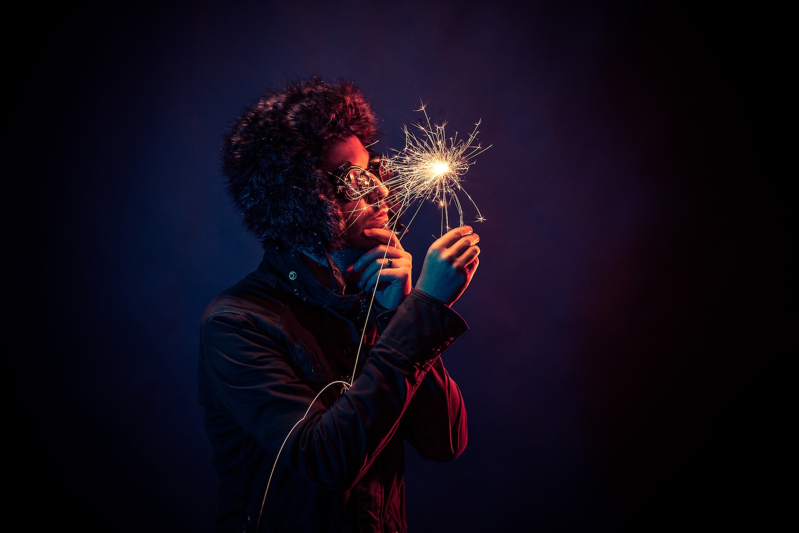 man in black jacket holding spark